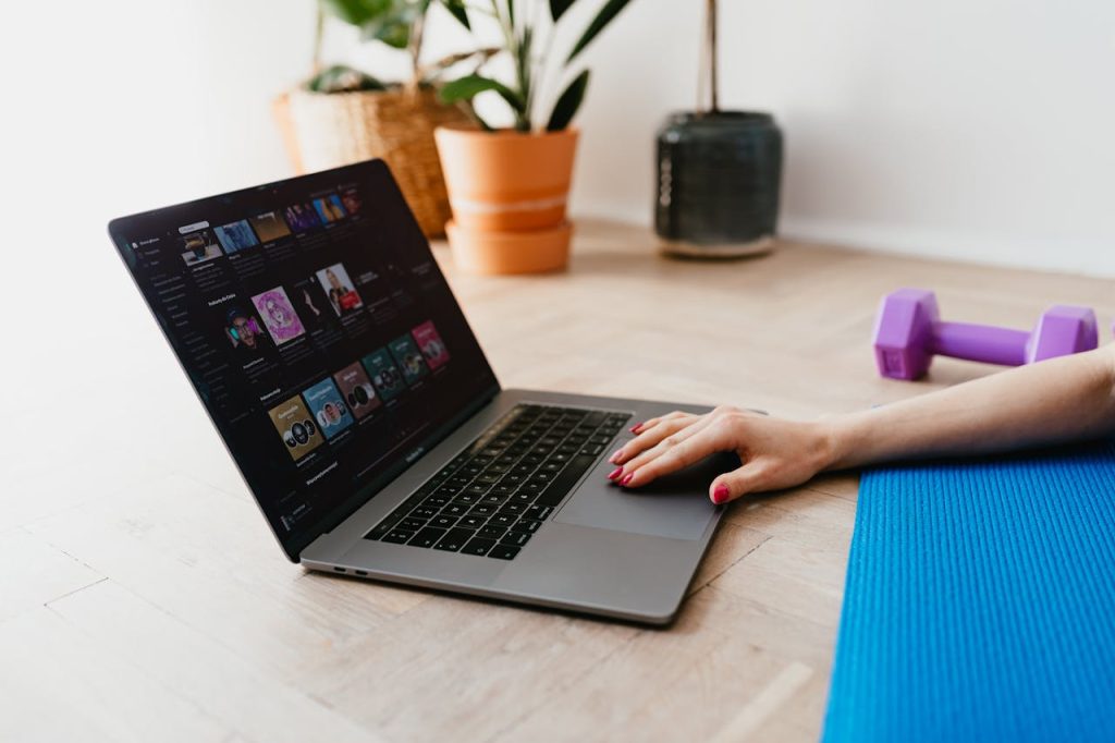 faceless-woman-using-laptop-during-sport-exercising-4498366 Hand of anonymous female on touchpad of laptop while surfing internet lying on mat at home during workout